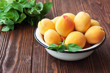 Naklejka na ściany i meble Bowl of harvested apricots