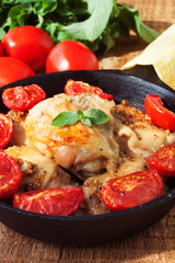 Mustard glazed chicken thighs with garlic and tomatoes