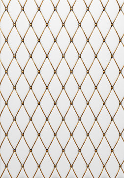 The white leather texture of the quilted skin with gold trim