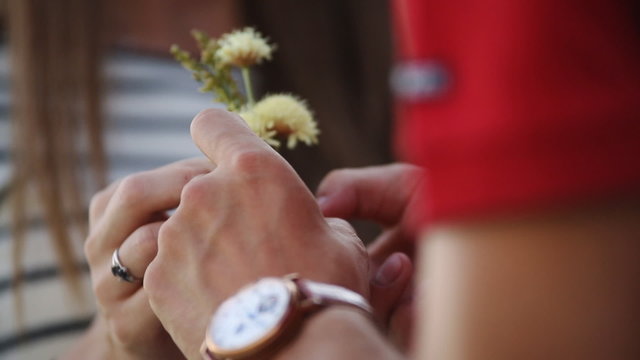 Rourke close-up of a young couple with flowers