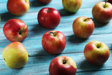 Fresh apples on a blue wooden table