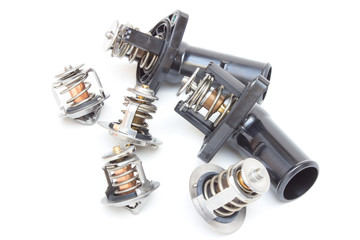 Parts of the car engine. Thermostat engine cooling system of the internal combustion machine. Spare parts on a white background