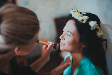 Beautiful young bride with wedding makeup and hairstyle in bedroom, newlywed woman final preparation for wedding. Happy Bride waiting groom. Marriage Wedding day moment. Bride portrait soft focus