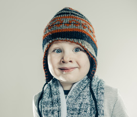 surprised boy portrait in hat and scarf