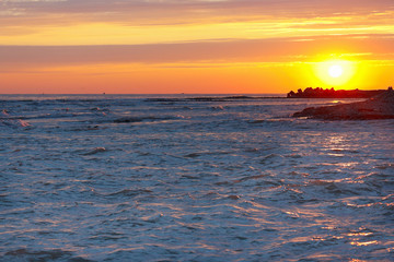 Tranquil sea sunset on a stony seashore