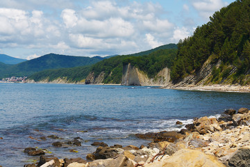 Fototapeta na wymiar Amazing rocky sea shore with the forest