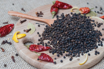 black pepper on wooden spoon