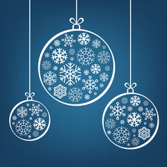 Hanging Christmas balls from snowflakes and ribbon on blue