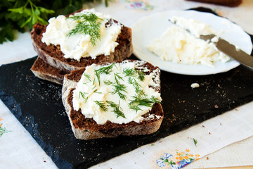 Rye bread and cream cheese with herbs