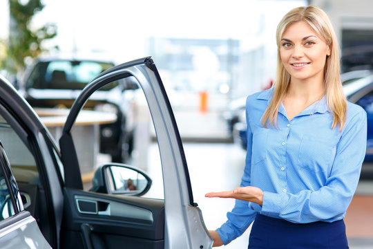 Sale assistant showing the car 