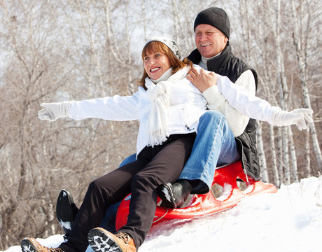 Mature Couple Sledding