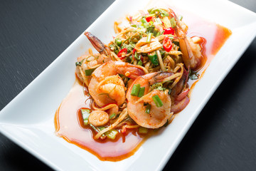Spicy salad Shrimp with lemon grass and mint on black background