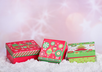 Fototapeta na wymiar Holiday Gift Boxes on Snow and Bright Colorful Background
