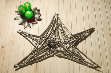 christmas star made of tree branches on wooden background
