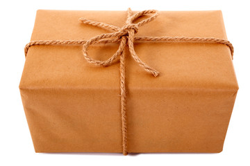 One single small plain brown paper package parcel gift or present tied with string shipping box delivery isolated on white background photo