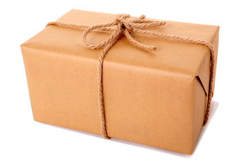 One single small plain brown paper package parcel gift or present tied with string shipping box...
