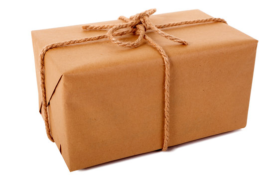 One single small plain brown paper package parcel gift or present delivery isolated on white background photo
