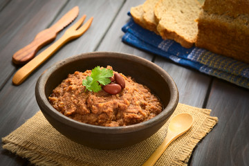 Rustic bowl of homemade red kidney bean spread garnished with kidney beans and fresh coriander...