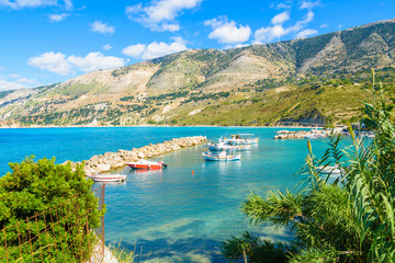 Greek fishing boats ion sea n port of Zola village with mountains in background, Kefalonia island,...