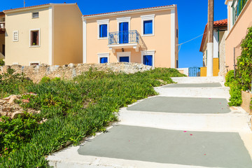 Fototapeta na wymiar Walkway in Assos town with typical Greek houses built in Venetian style, Kefalonia island, Greece