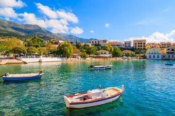 Fototapeta na wymiar Greek fishing boats on sea in beautiful bay, Assos village, Kefalonia island, Greece
