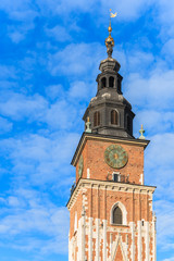Fototapeta na wymiar City Hall tower against blue sky on main market square of Krakow, Poland