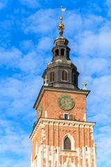 Fototapeta na wymiar City Hall tower against blue sky on main market square of Krakow, Poland