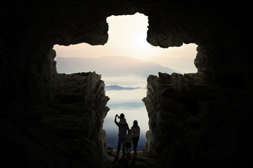 Happy family inside cave shaped cross sign