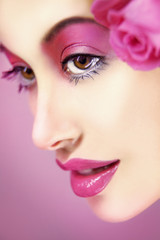 beautiful woman in pink with perfect make up and roses