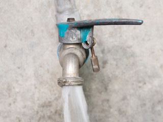 Close up old faucet on tile wall for background.