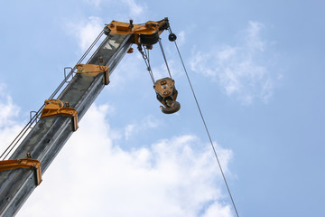 Lifting crane on blue sky background in industry atmospheric