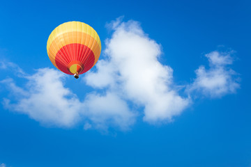 Fototapeta na wymiar Colorful hot air balloon with blue sky background