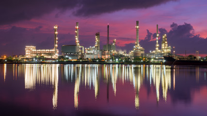 Fototapeta premium Oil tank ship mooring in oil refinery industry at twilight time