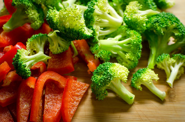 Sliced Vegetables - Broccoli and Red Peppers on Wooden Cutting Board