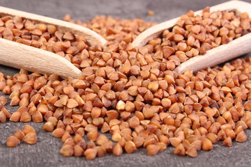Buckwheat groats with spoon on cement structure