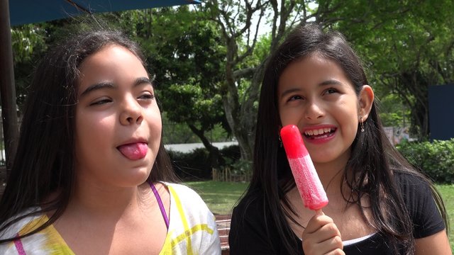 Young Girls Eating Popsicles