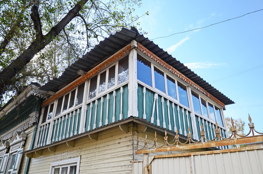 Old two-storey wooden house with glazed attic. Irkutsk streets