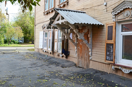 Two-storey wooden house with porch and window shutters on Irkutsk street
