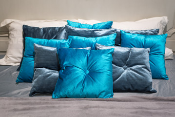blue pillows on grey bed