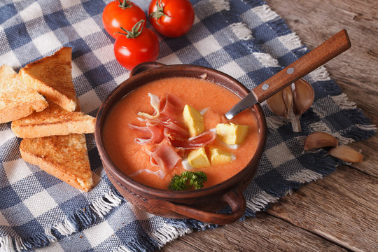 Salmorejo soup with ham and eggs on the table. horizontal
