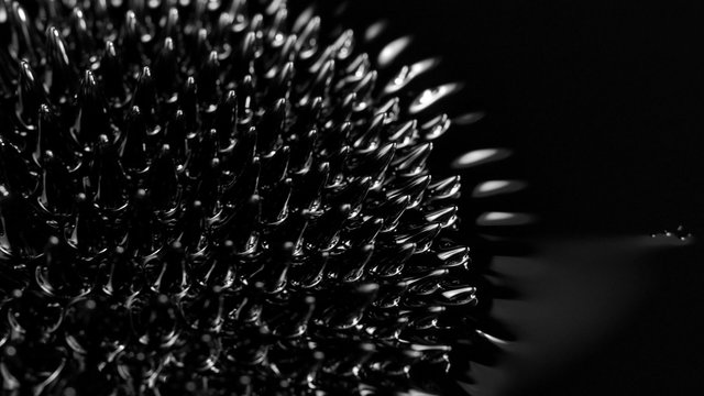 Black liquid surface. Abstract background. Ferrofluid. Сlose-up. 4K UHD 2160p footage.