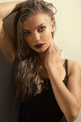 Fototapeta premium Portrait of beautiful young woman with long wet hairs. Low key s