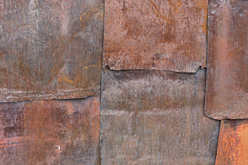 Scratched and spotted rusty metal background.