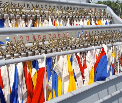 The row of nautical flags closeup on ship