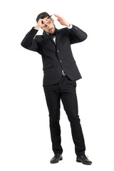 Preparation of elegant young groom combing his hair. Full body length portrait isolated over white studio background.