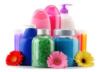 Plastic bottles of body care and beauty products over white
