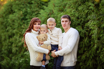 beautiful happy family in sweaters with his two sons in the fore