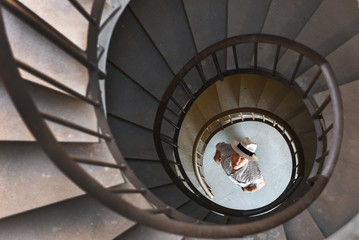 spiral staircase with a man below