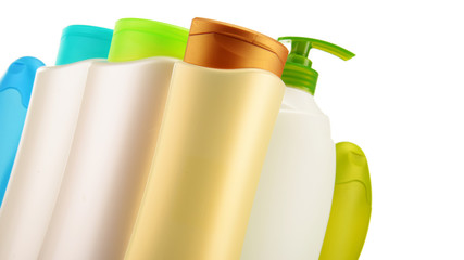 Plastic bottles of body care and beauty products over white