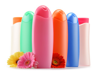 Plastic bottles of body care and beauty products over white